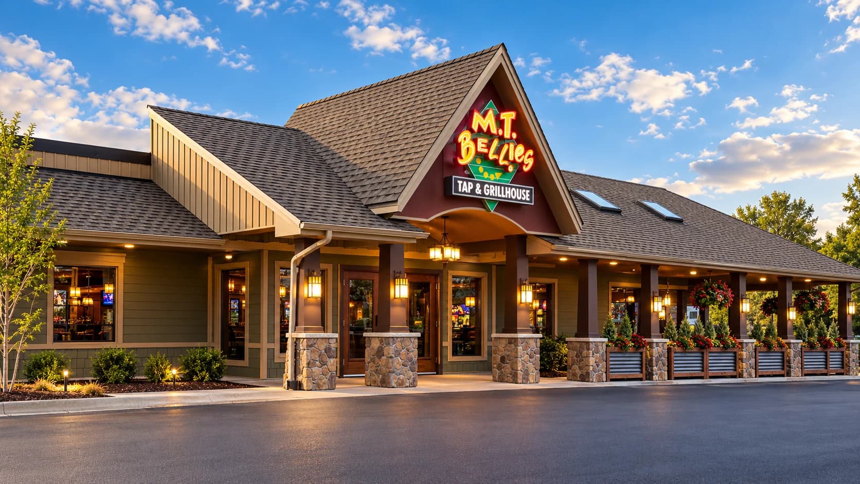 M.T. Bellies restaurant in Welland with a peaked entrance roof, illuminated sign, stone-clad columns and a covered patio