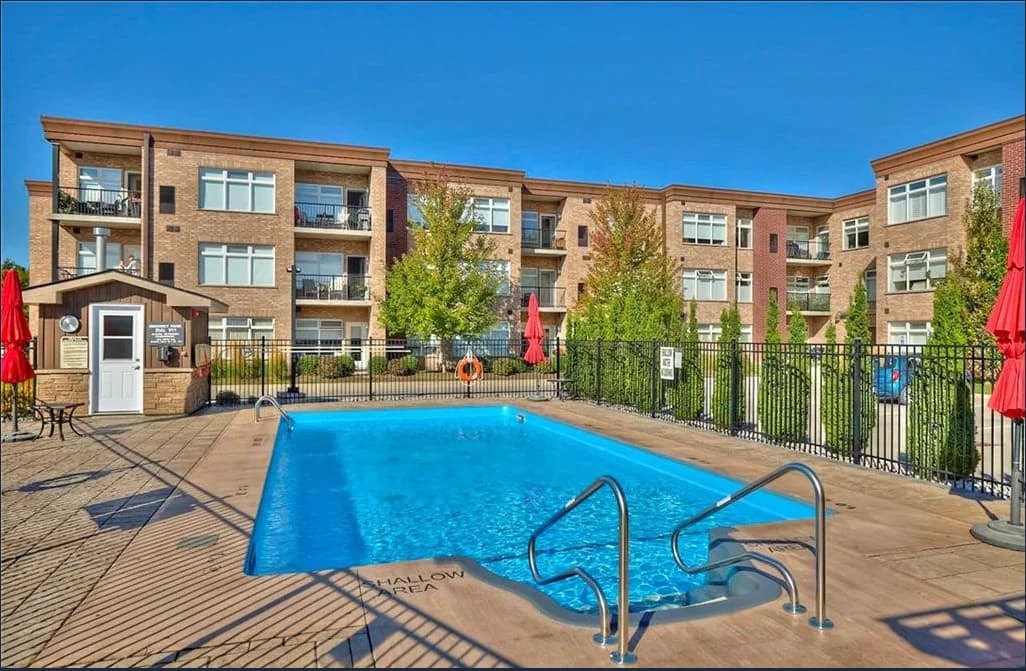 Olympia's outdoor swimming pool enclosed by black railings with private balconies overlooking the courtyard